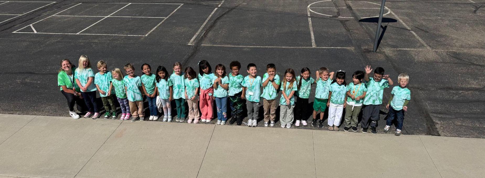 BES classroom students wearing green outside.