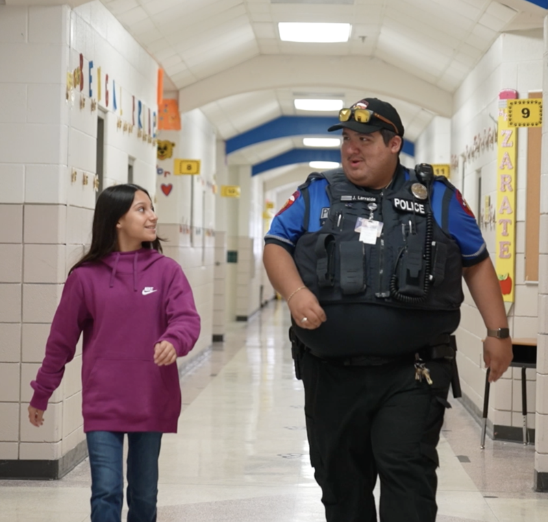 Edinburg CISD Student walking with Cop