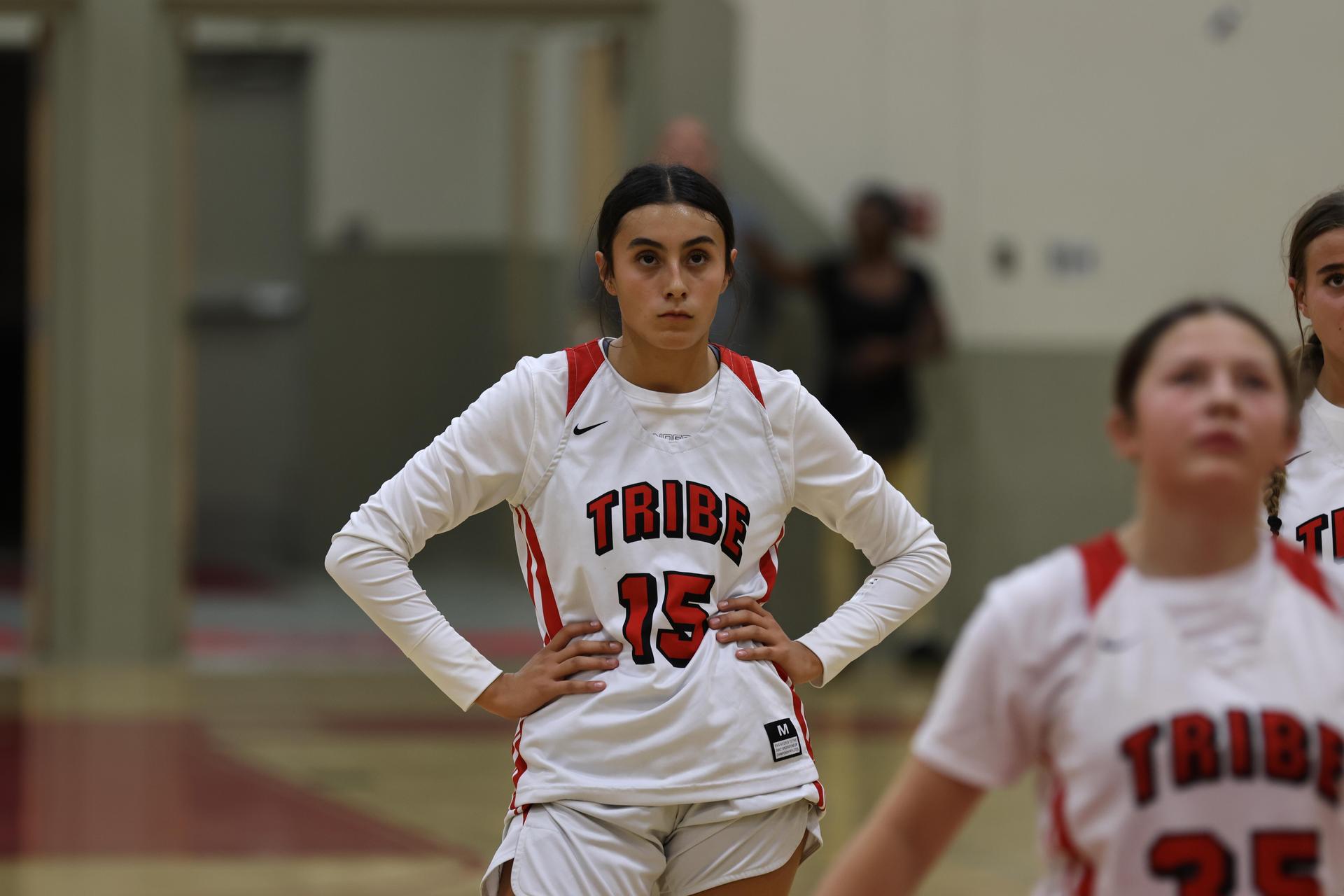 varsity girls playing basketball against mclane