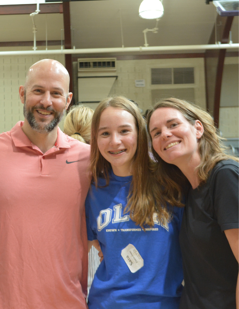 photo of family with arms around each other