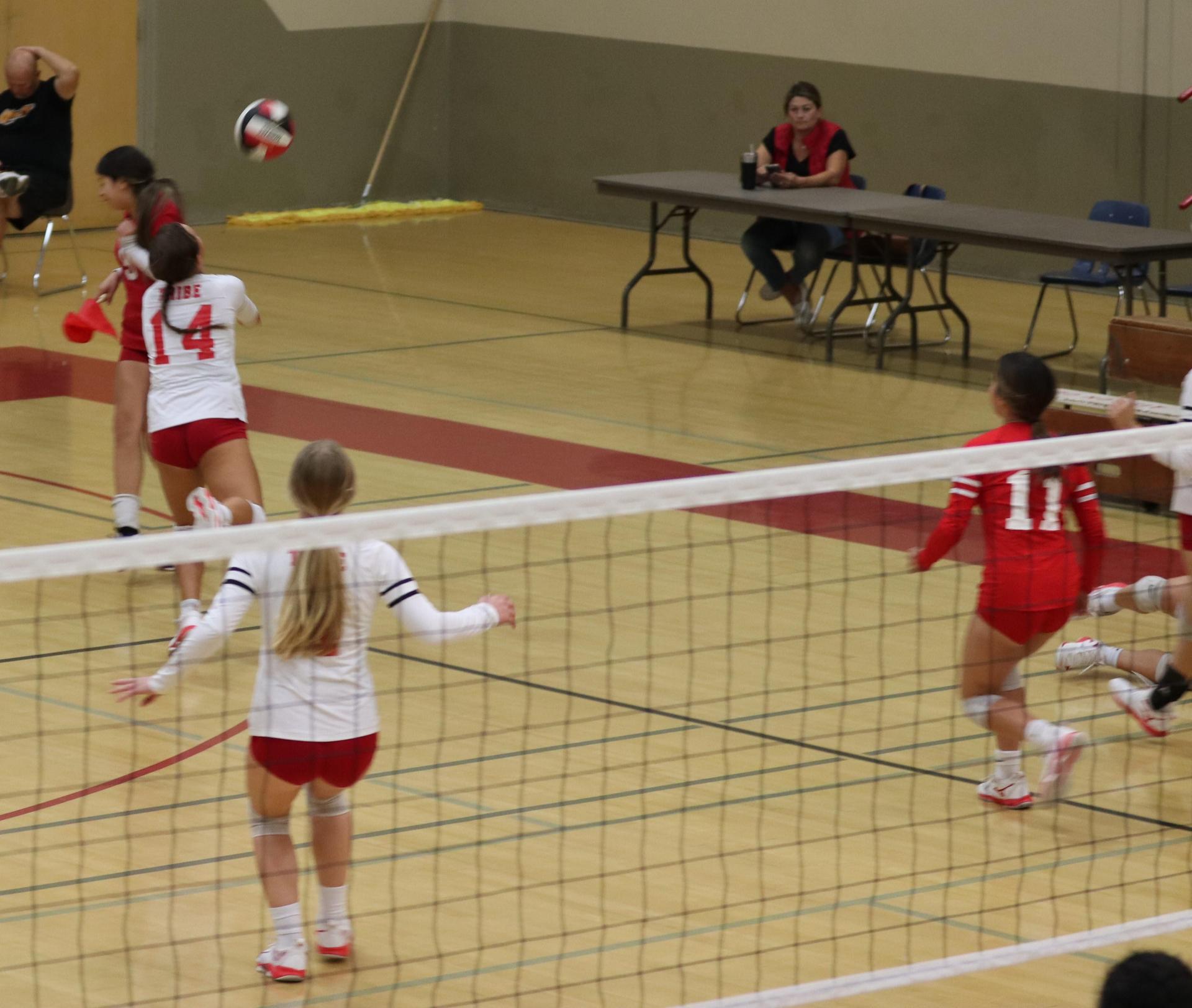 varsity volleyball players in action against Fresno Christian