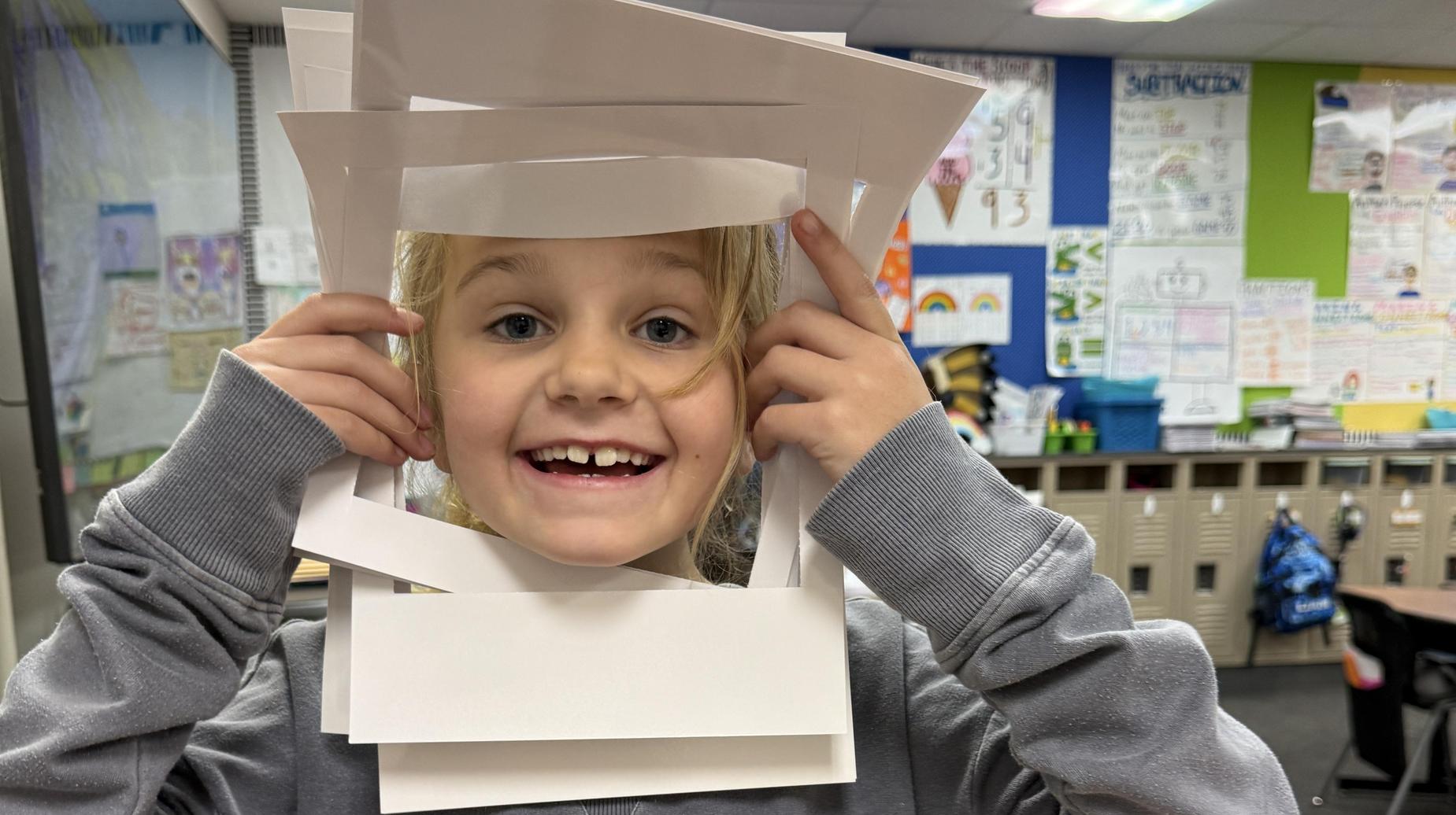 Seminole Primary student smiling with paper frames