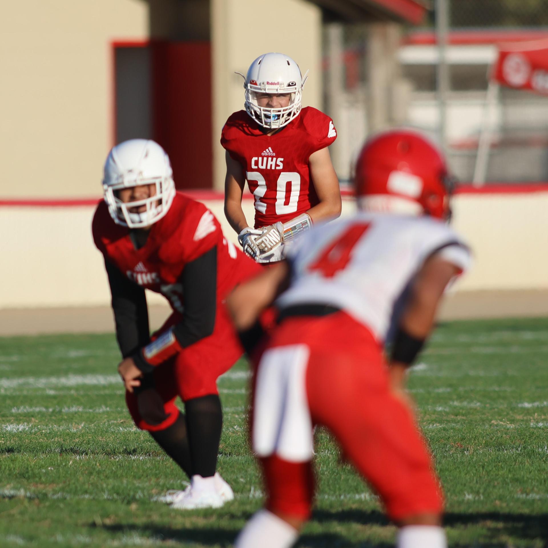 junior varsity football players in action against Fowler