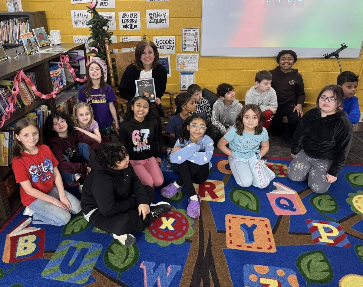 photo - Kendall students pose for a photo with Superintendent Stephanie Lockwood, who was there to read to their class
