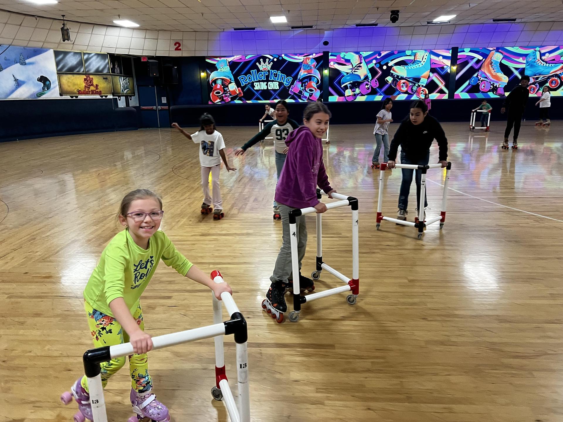 Students in motion at skating rink 