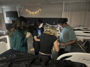 students work together to solve clues in haunted escape room