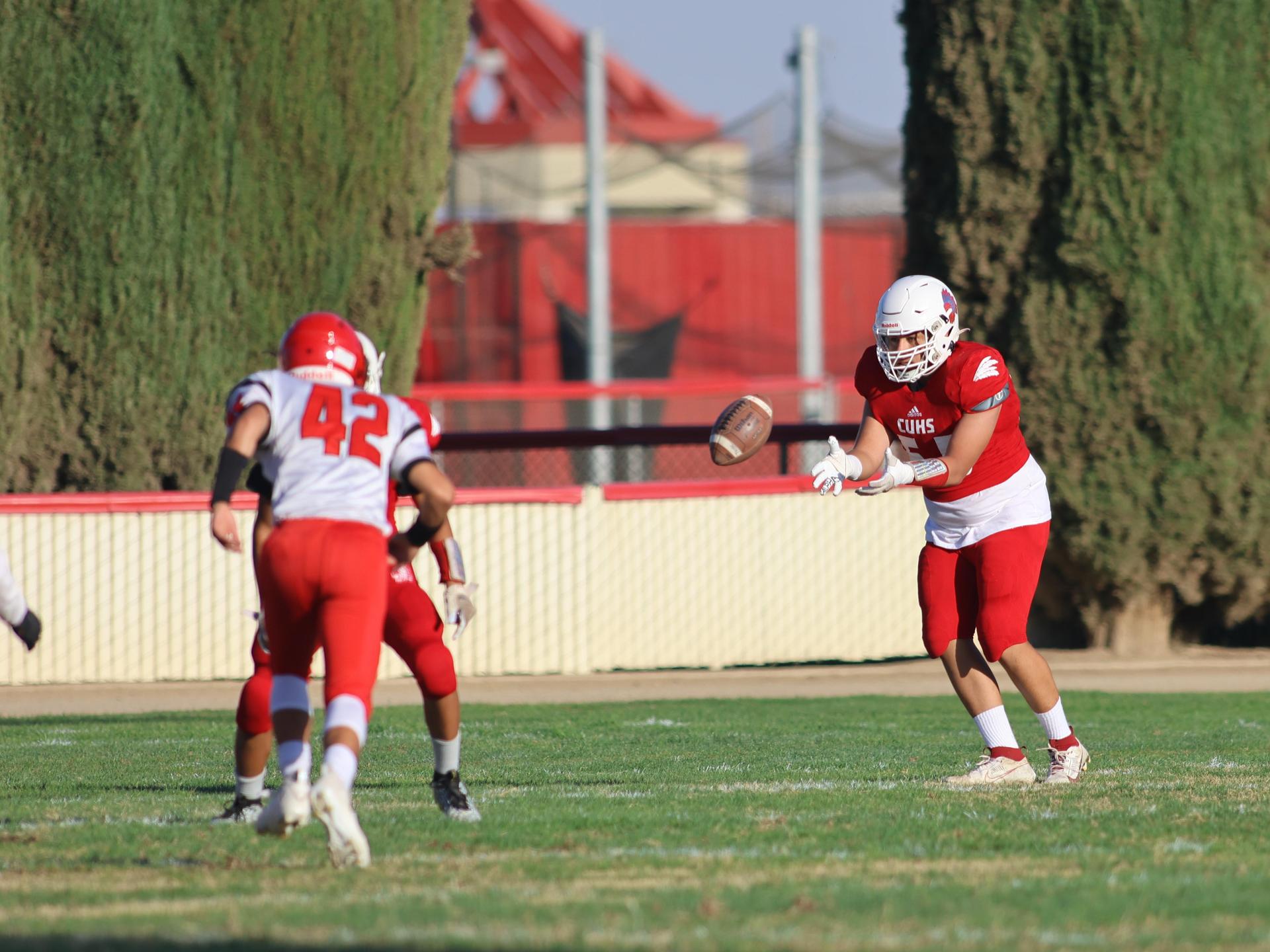 junior varsity football players in action against Fowler