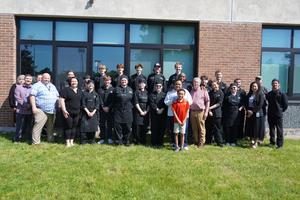18 culinary arts students with Chef Eaddy and administrators