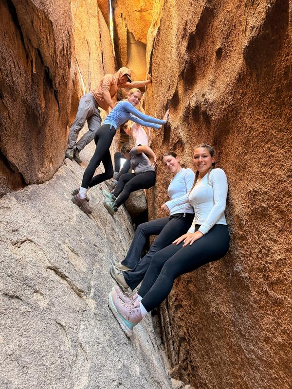 Group of students posing while on a cavern climb