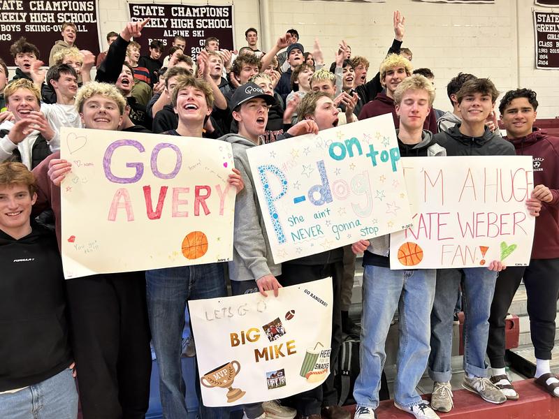 Unified basketball game crowd holding posters in support