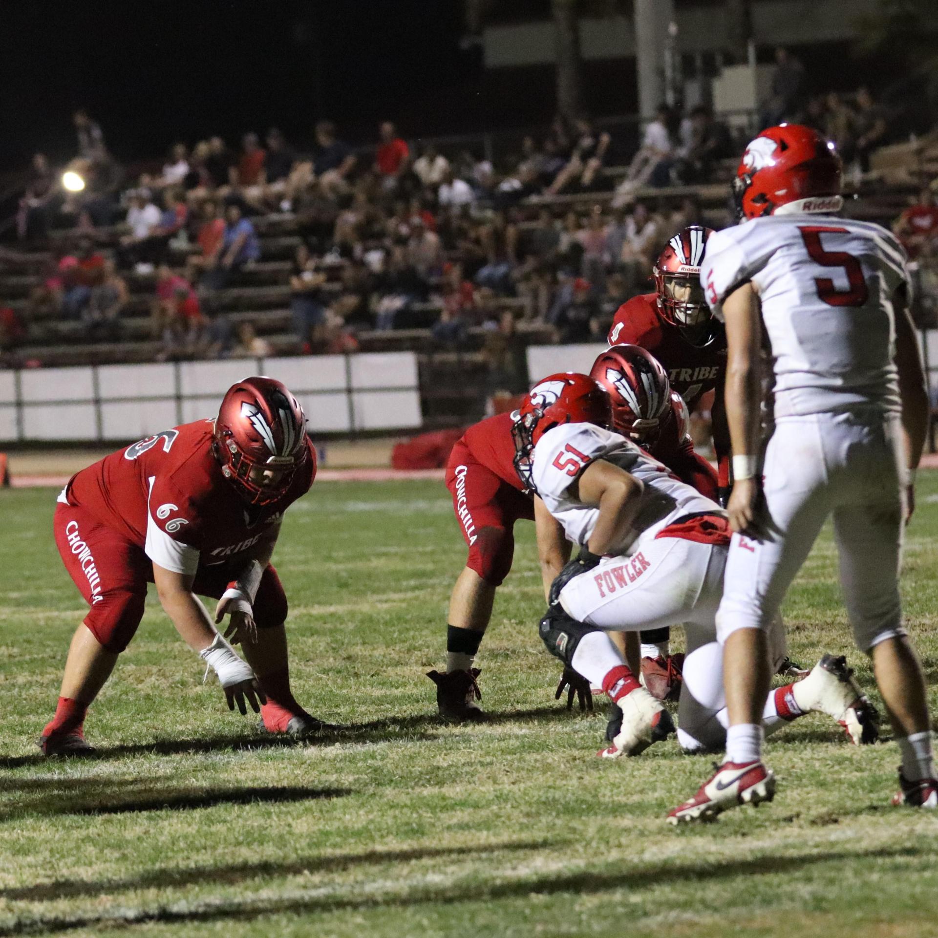 varsity boys playing football against Fowler