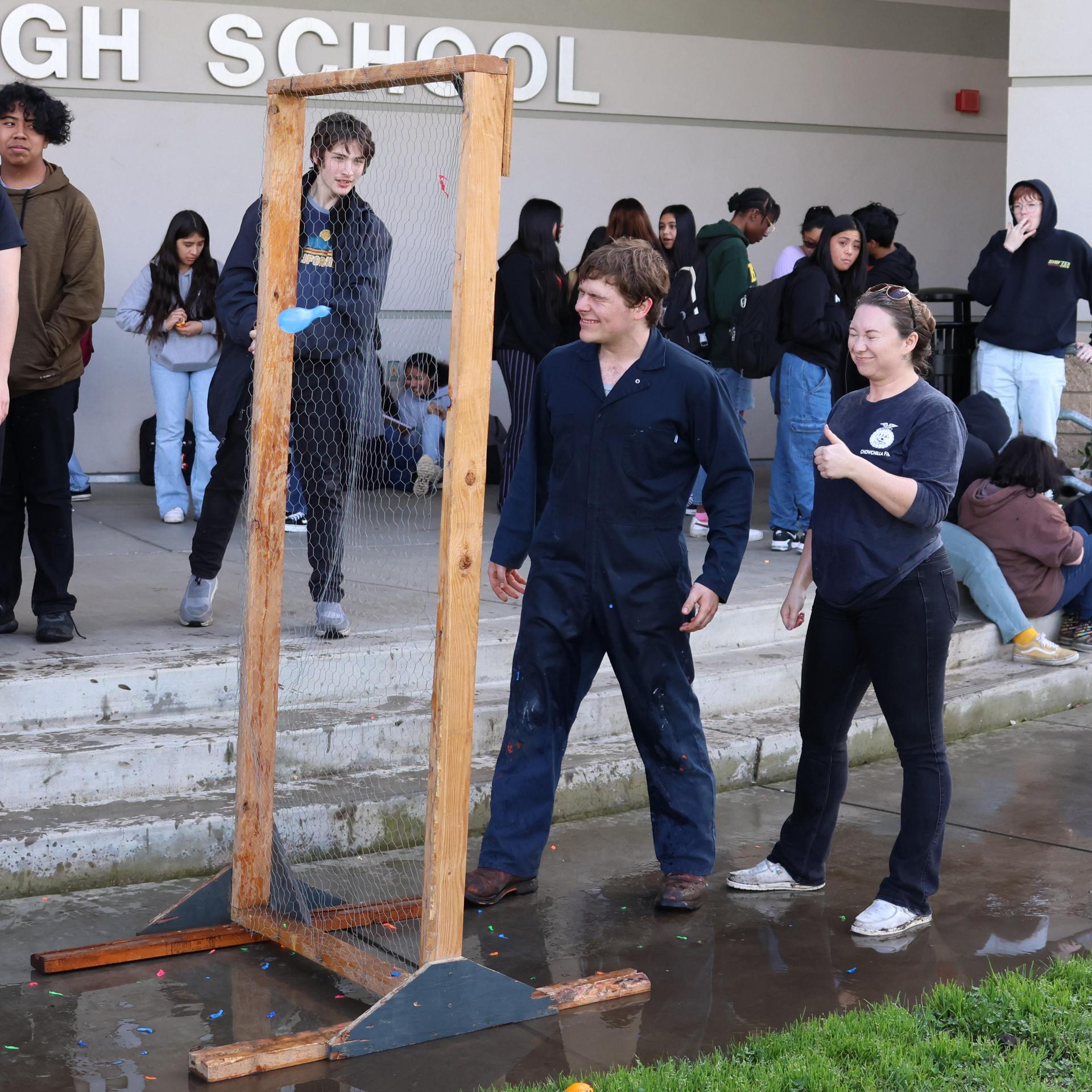 students and staff enjoying the water balloon toss