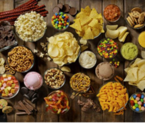 Birds eye view of table scape filled with various bowls of snacks