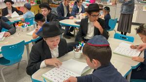 ninth graders learning with the kindergarteners