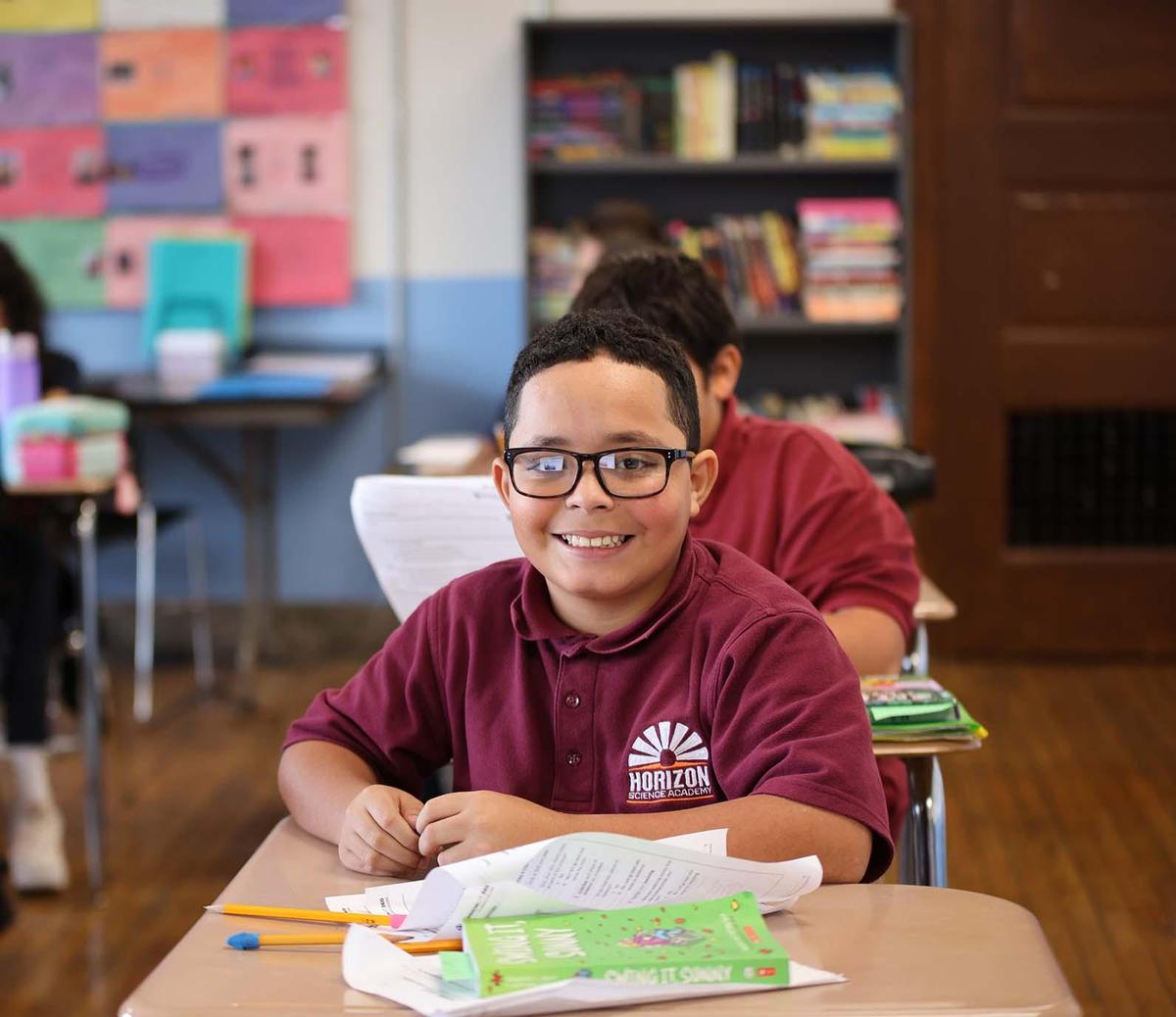 HSA Davenport student wearing headphones uses a laptop in class