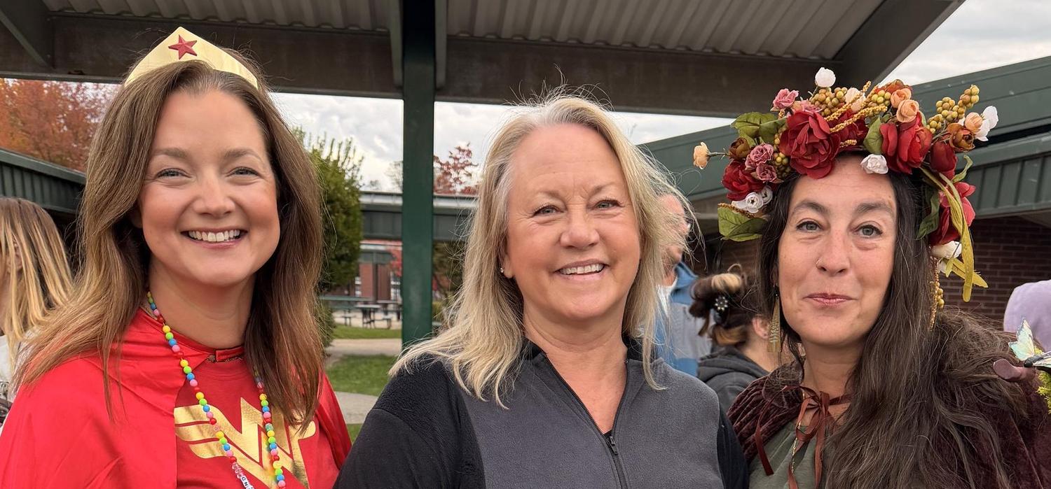 Principal Bevel and the two secretaries posing in Halloween costumes