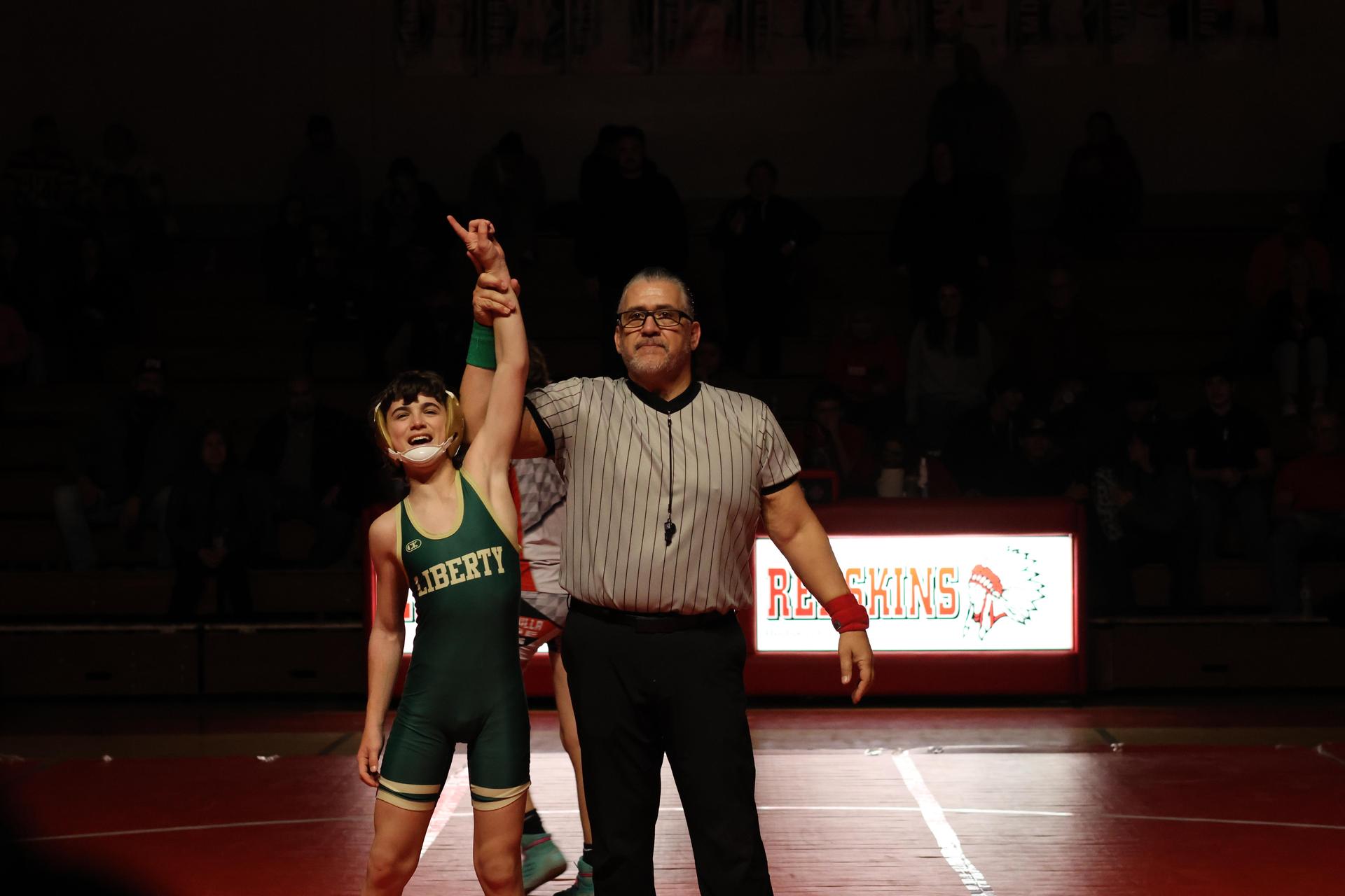 Wrestling winners with hands up 136