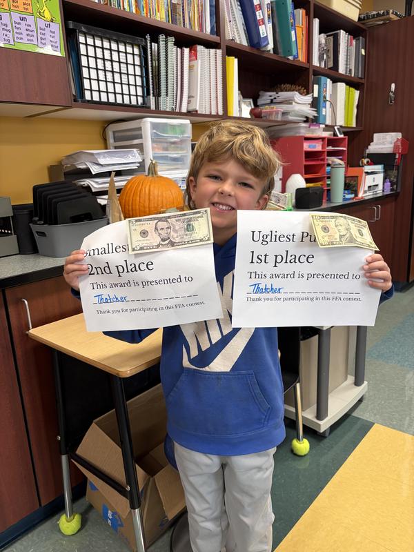 Student showing off his awards.