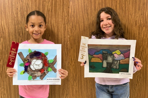 Willow Bend art students posing with their artwork and ribbons.