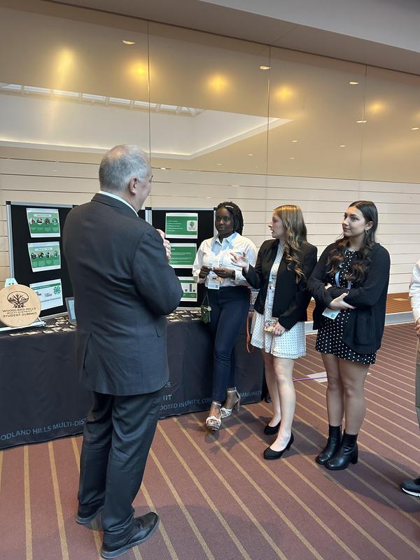 Students meet with a visitor