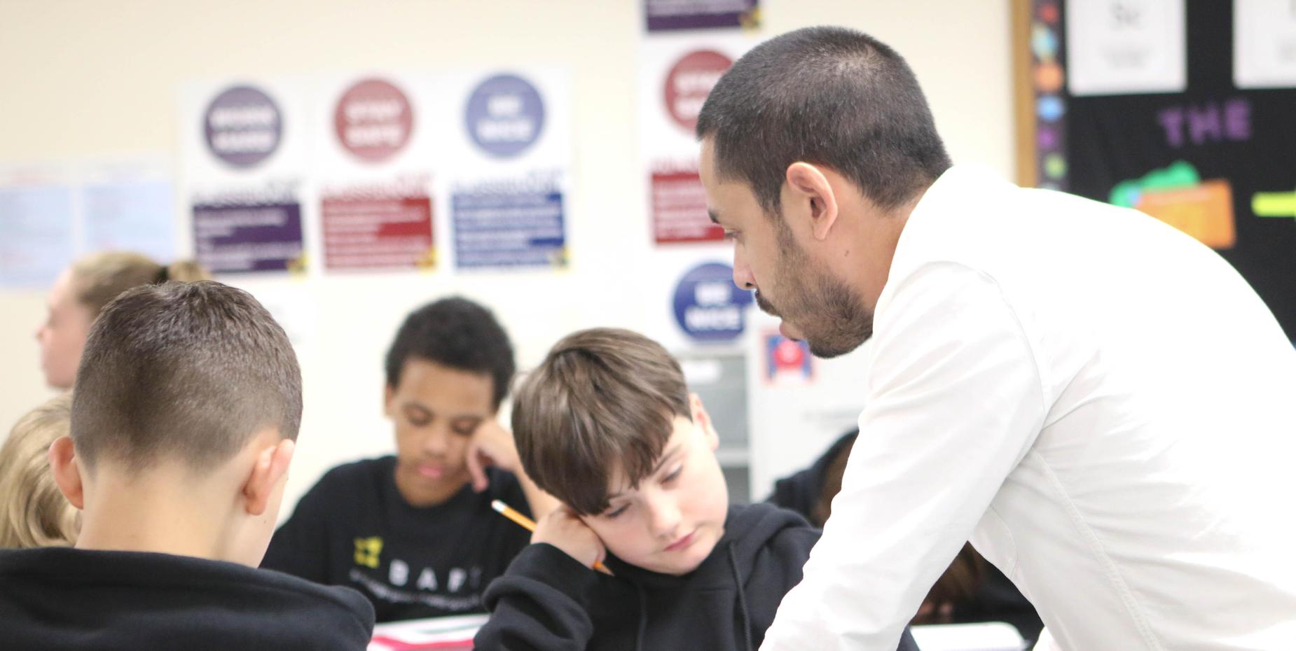 A teacher helping a student with classwork