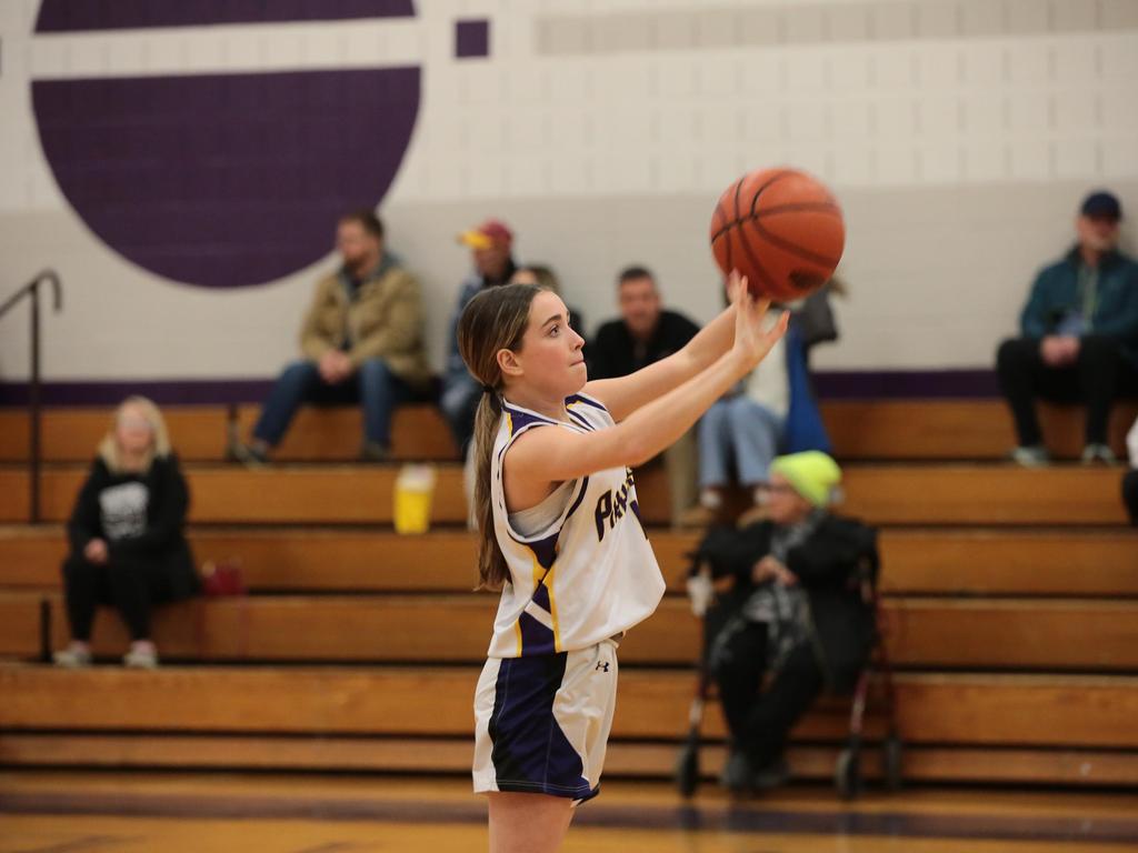 A student athlete shooting a basketball.