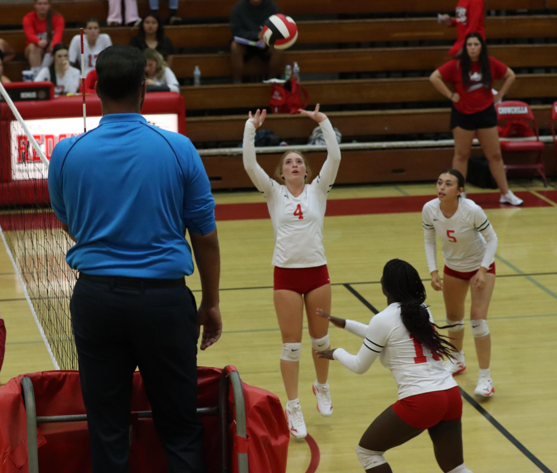 varsity volleyball players in action against golden valley