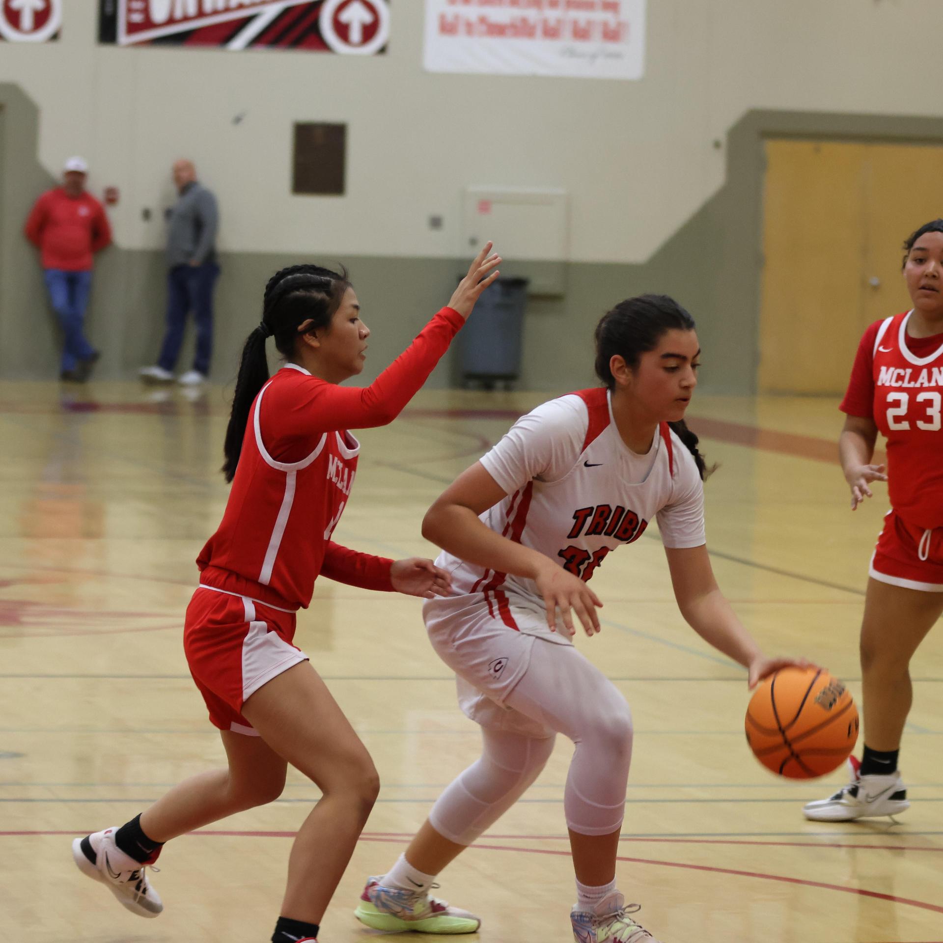 varsity girls playing basketball against mclane