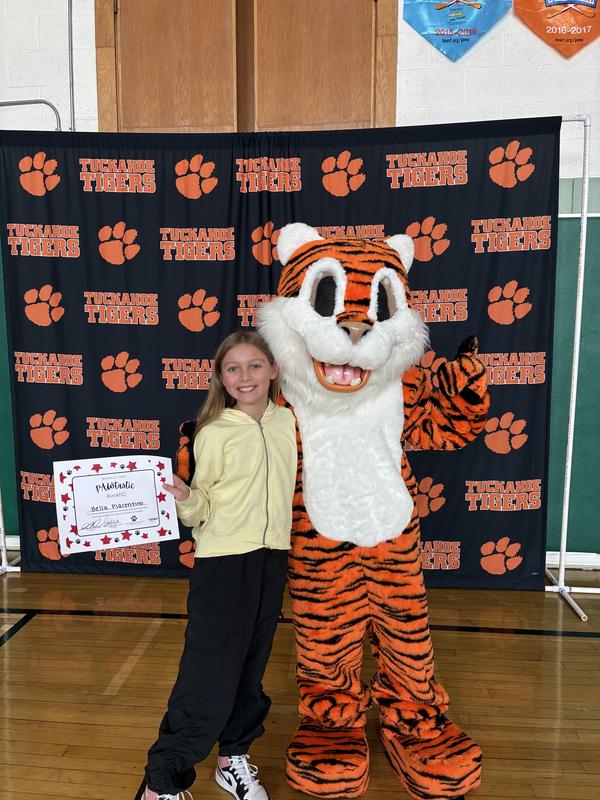 Student and Tiger mascot at awards ceremony