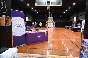Interior of a gym with a banner and decorations for an event in a brightly lit space.