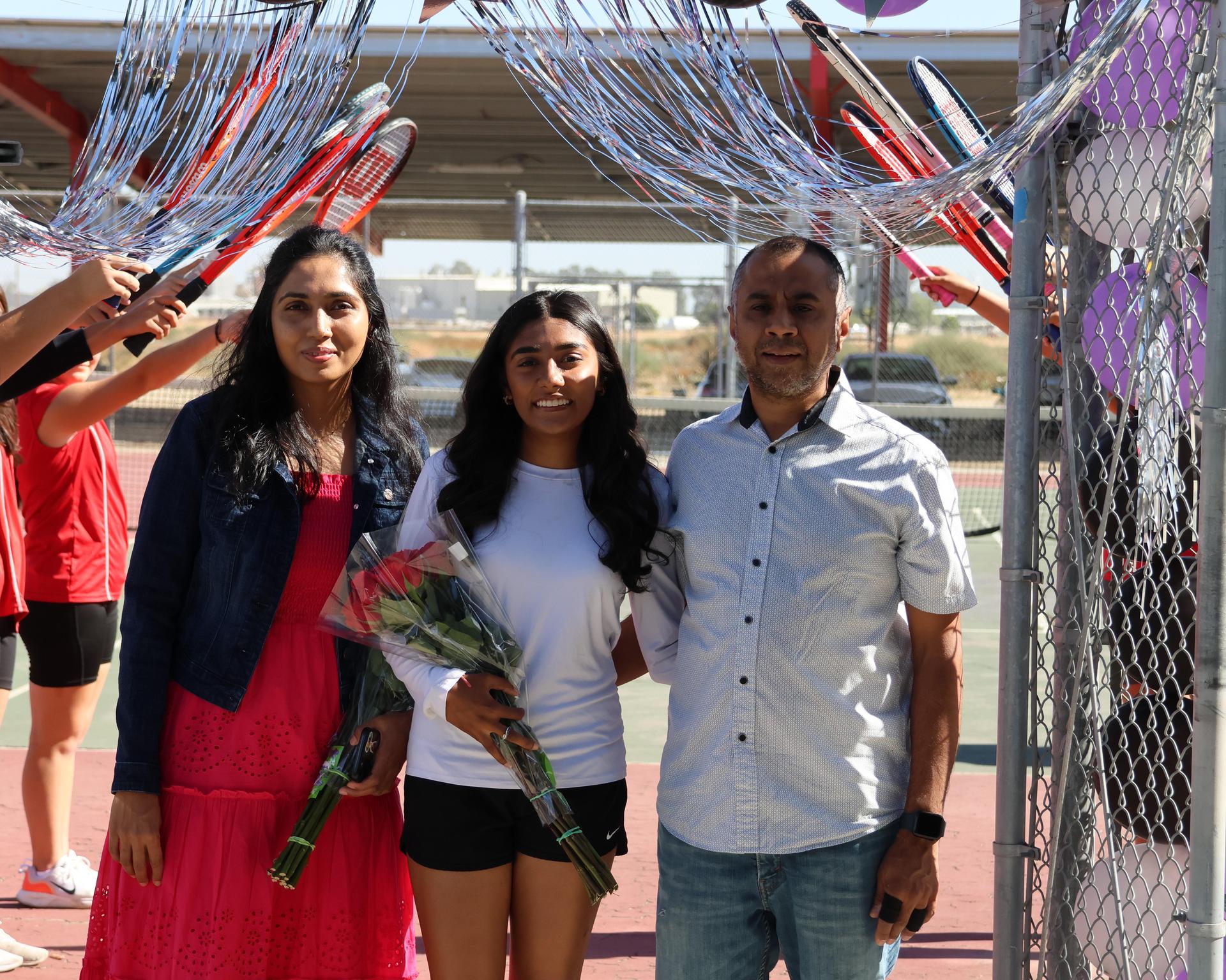 tennis players, family, and staff celebrating senior night