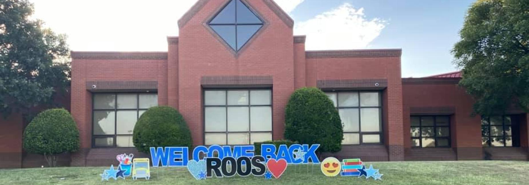 photo of Austin Elementary with yard signage that spells out Welcome Back Roos