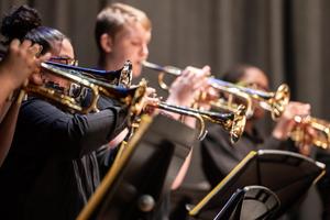 Students play brass instruments
