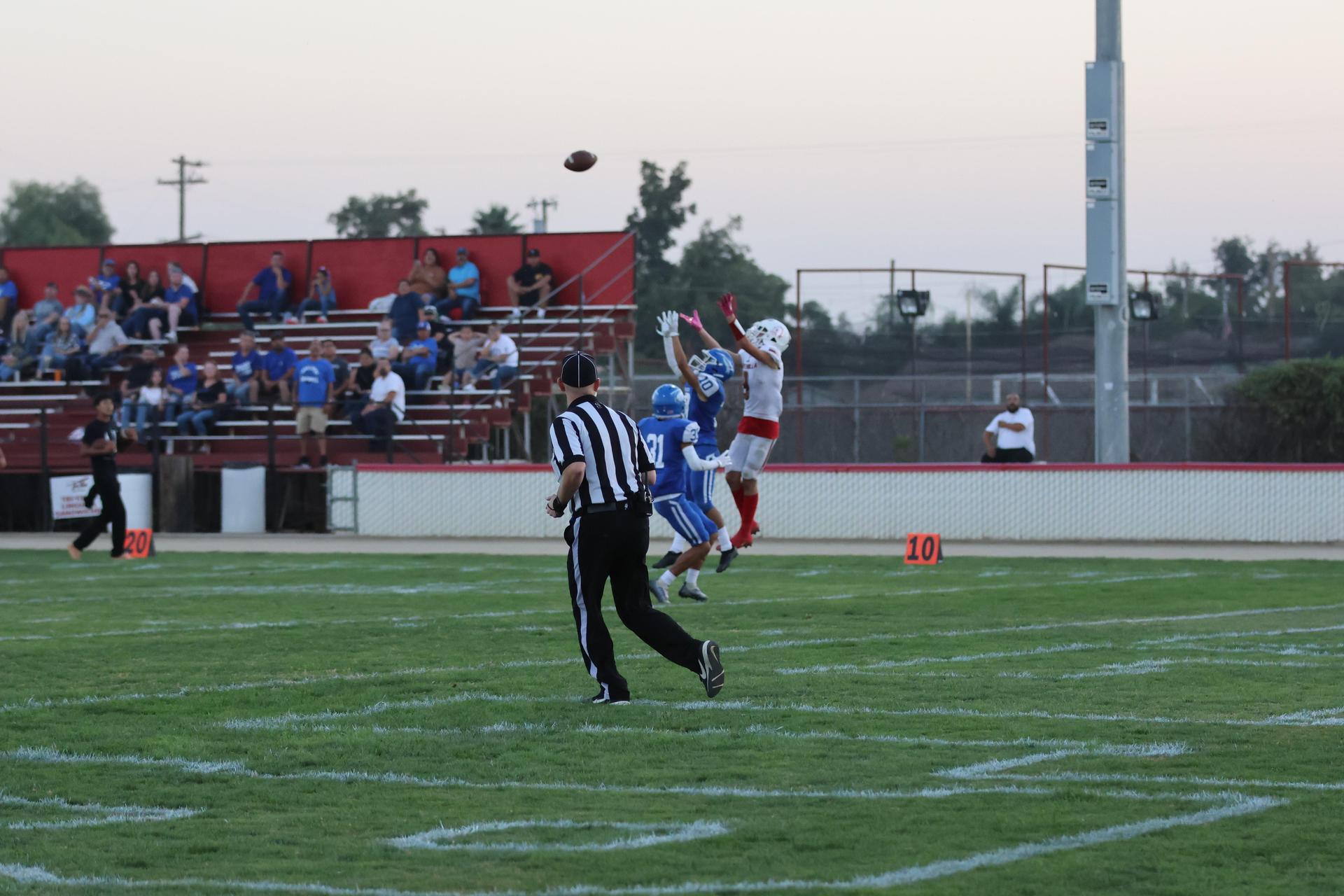 Junior Varsity football players in action against Caruthers