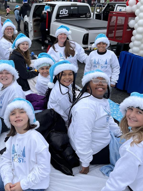 smiling kids sitting on a float in a parade