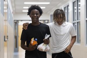 Two middle school boys laugh and smile