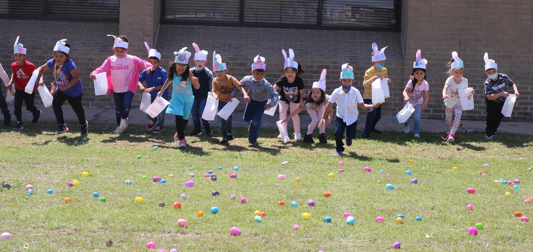 kinder students hunt for numbered easter eggs