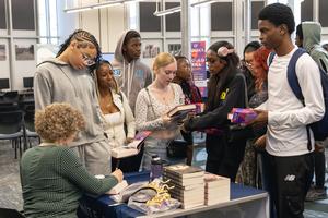 Students wait to have their books signed