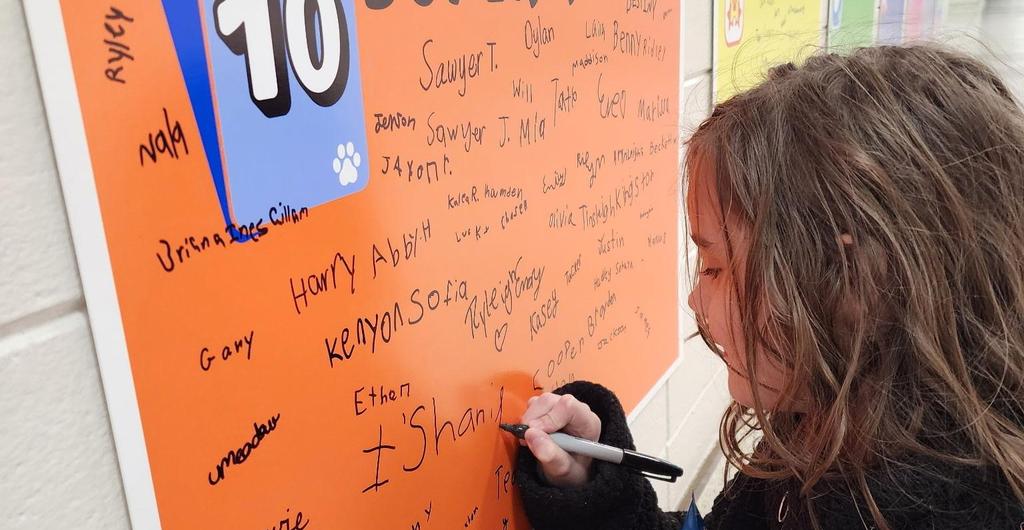 student signing AR wall
