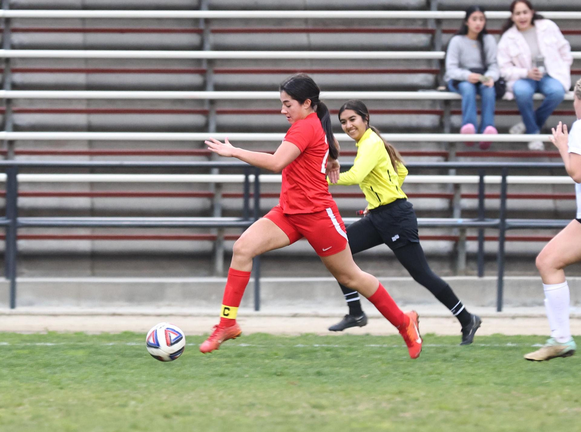 Junior varsity girls playing soccer against liberty