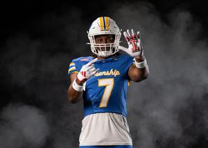 chase campbell media day image with football