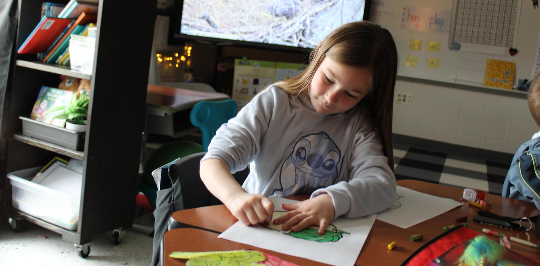 girl coloring in a classroom