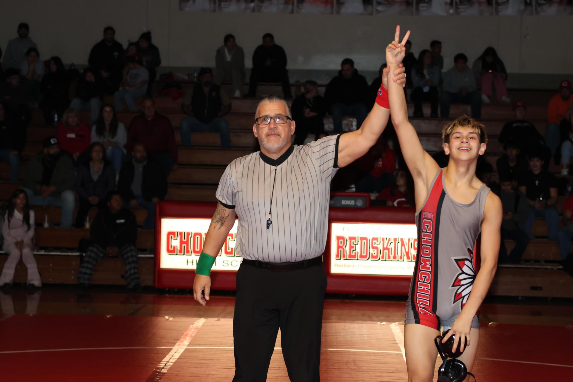 Wrestling winners with hands up 25