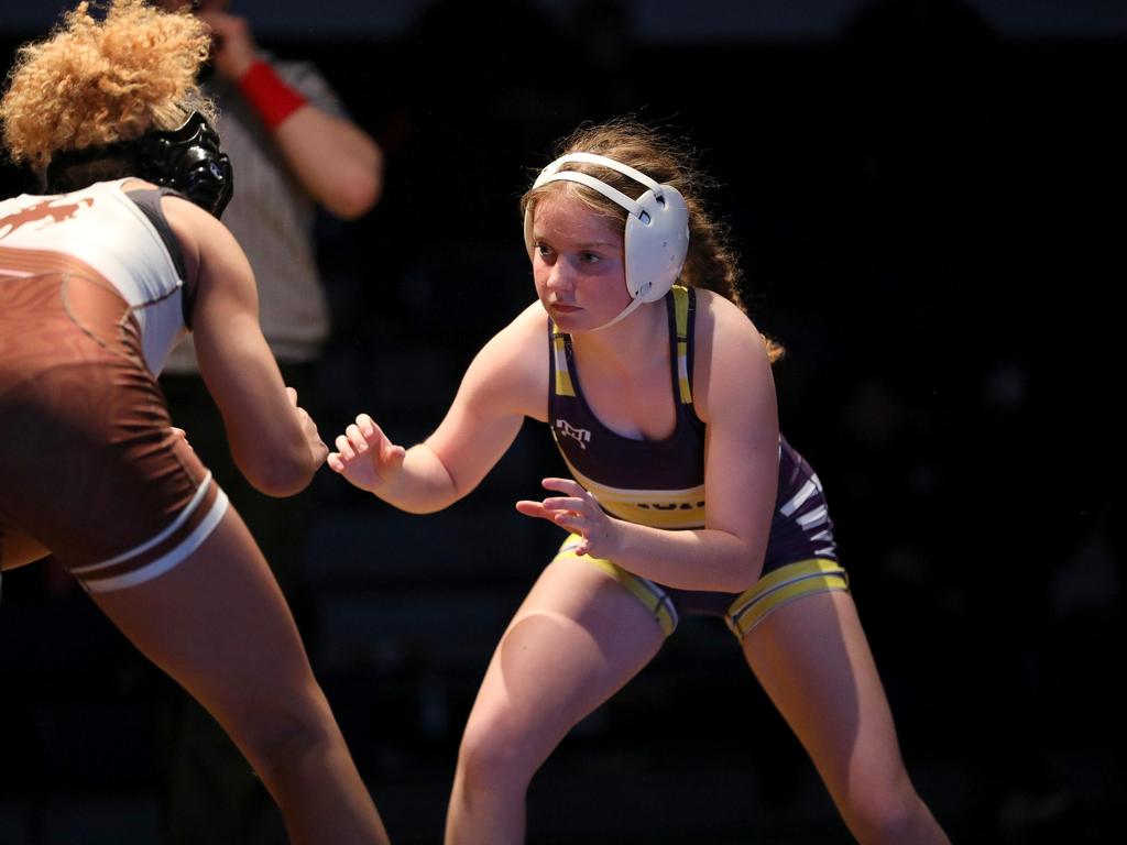 A female wrestler in a match.