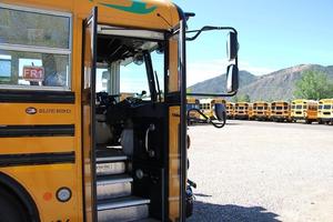 Outside of a school bus parked at a bus barn