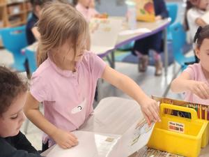 A student changes a word on her word board