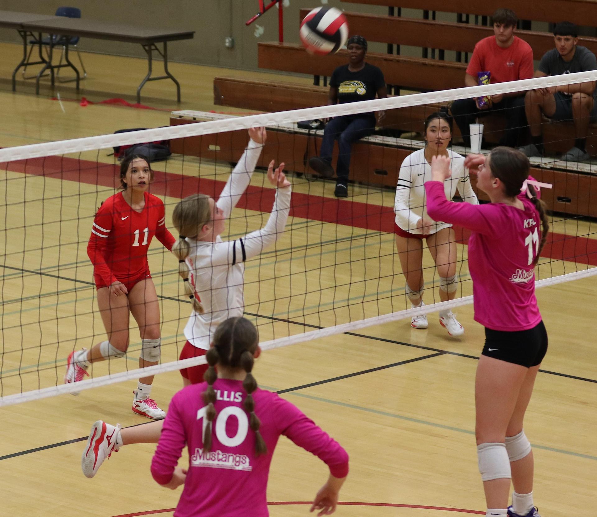 varsity volleyball players in action against Minarets