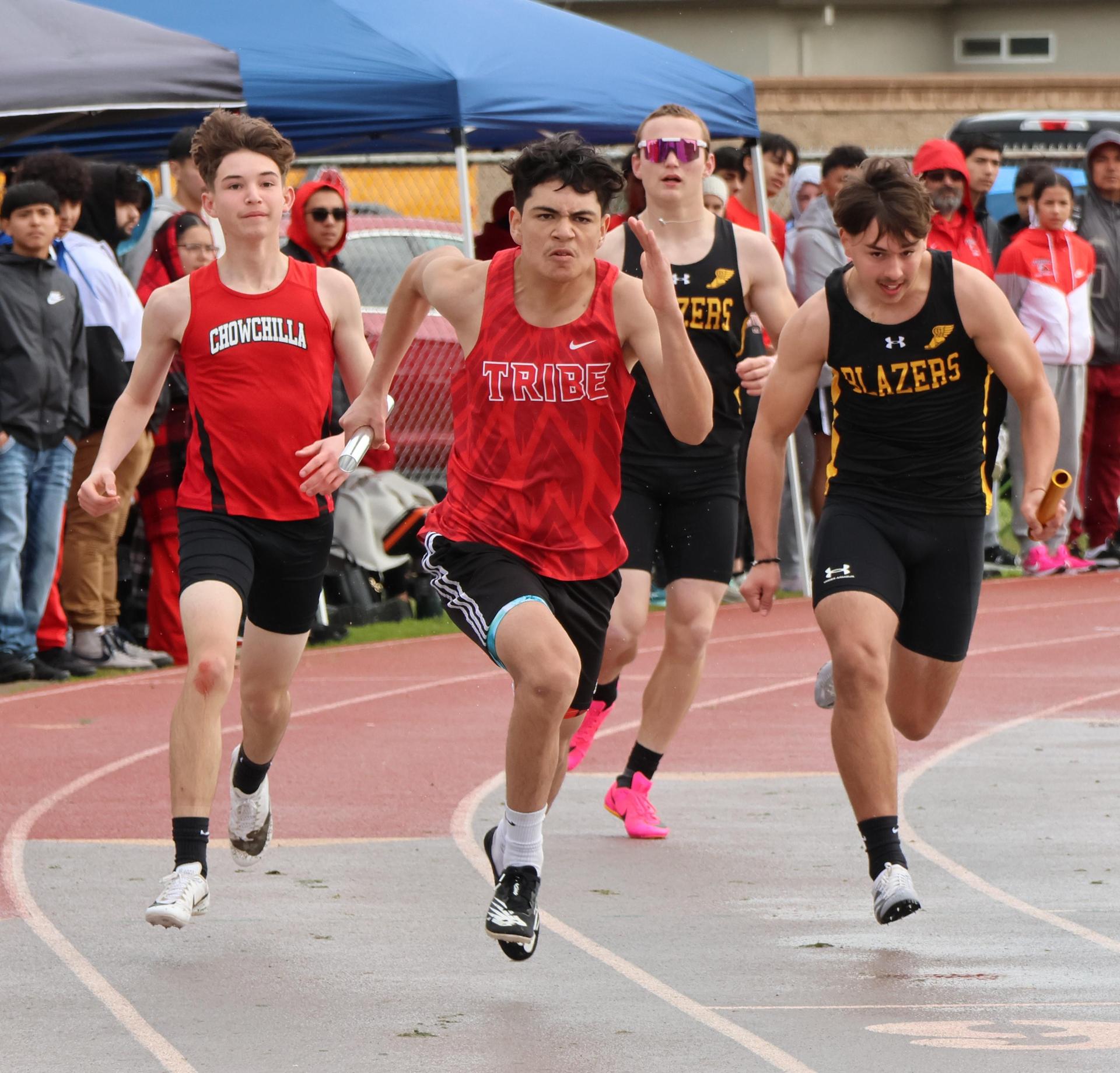 junior varsity boys running the four by 100 meter relay