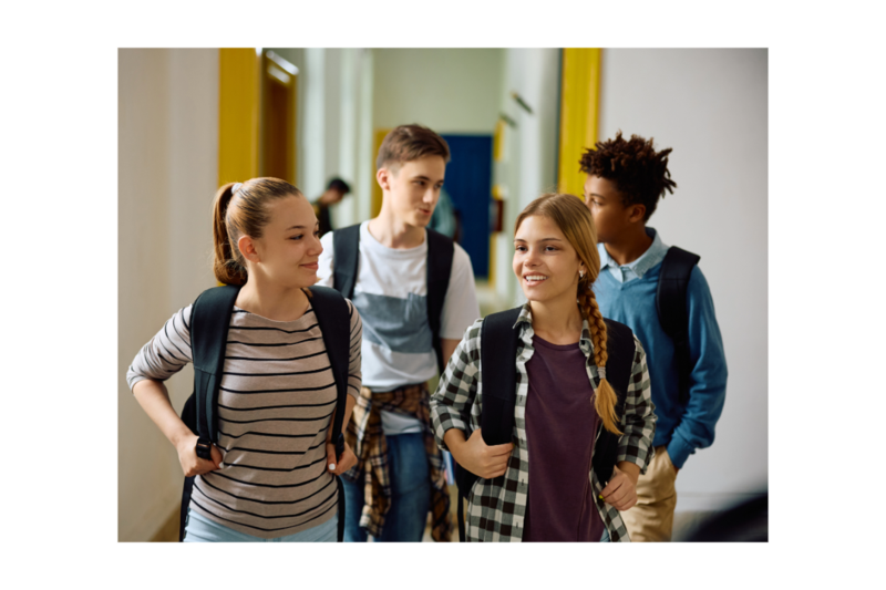 Four students walk through the school's hallway