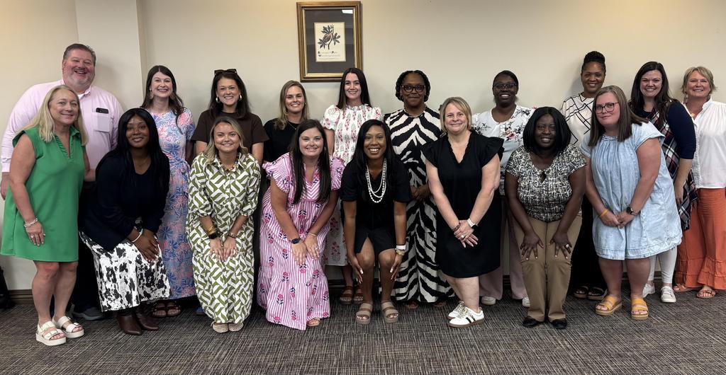 New Teachers pose for picture at luncheon with their mentors.